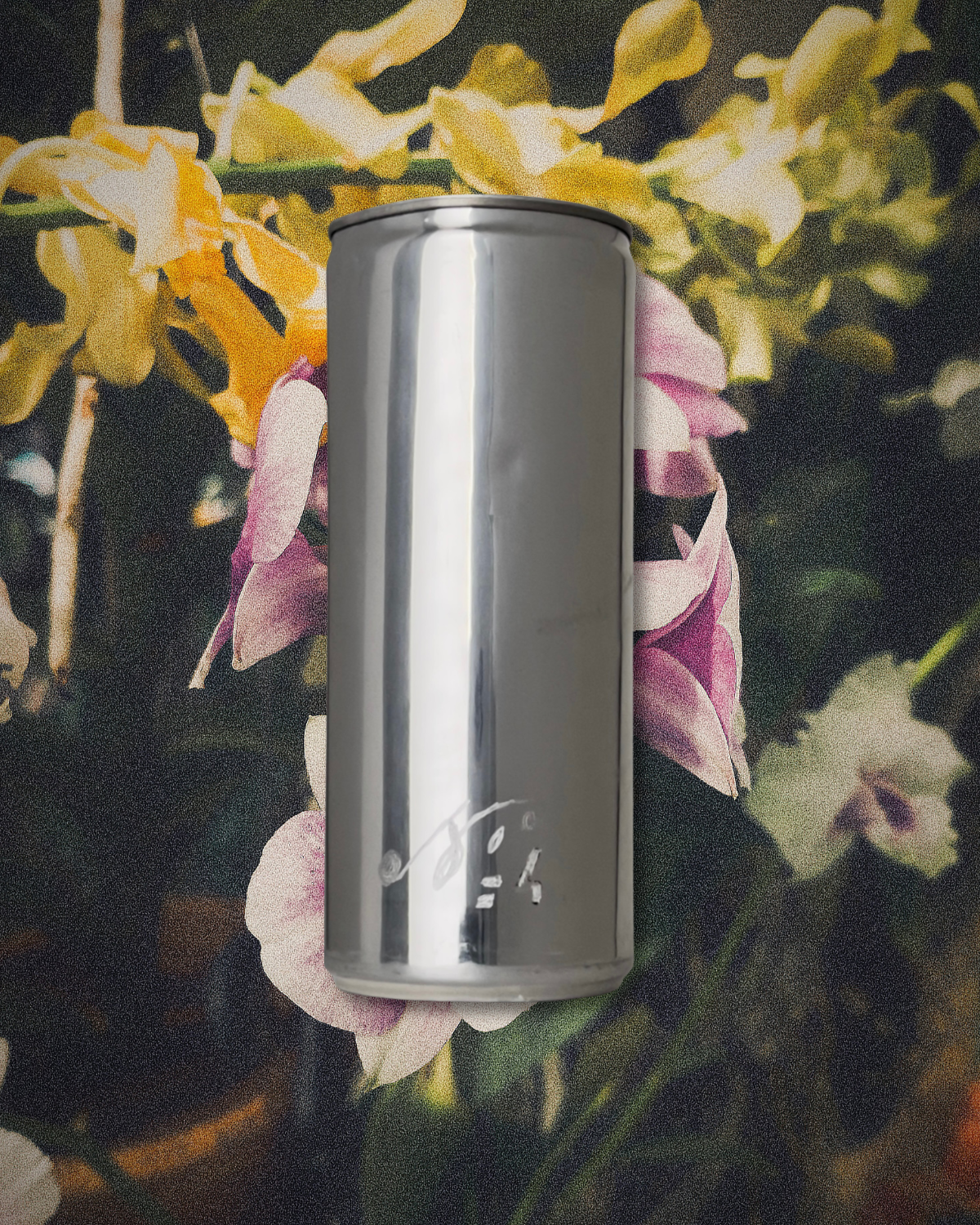 Sloan Rose N°4 Orchid & Summer Storm candle in a reclaimed aluminum vessel, among orchids in dark, storm dimmed light.