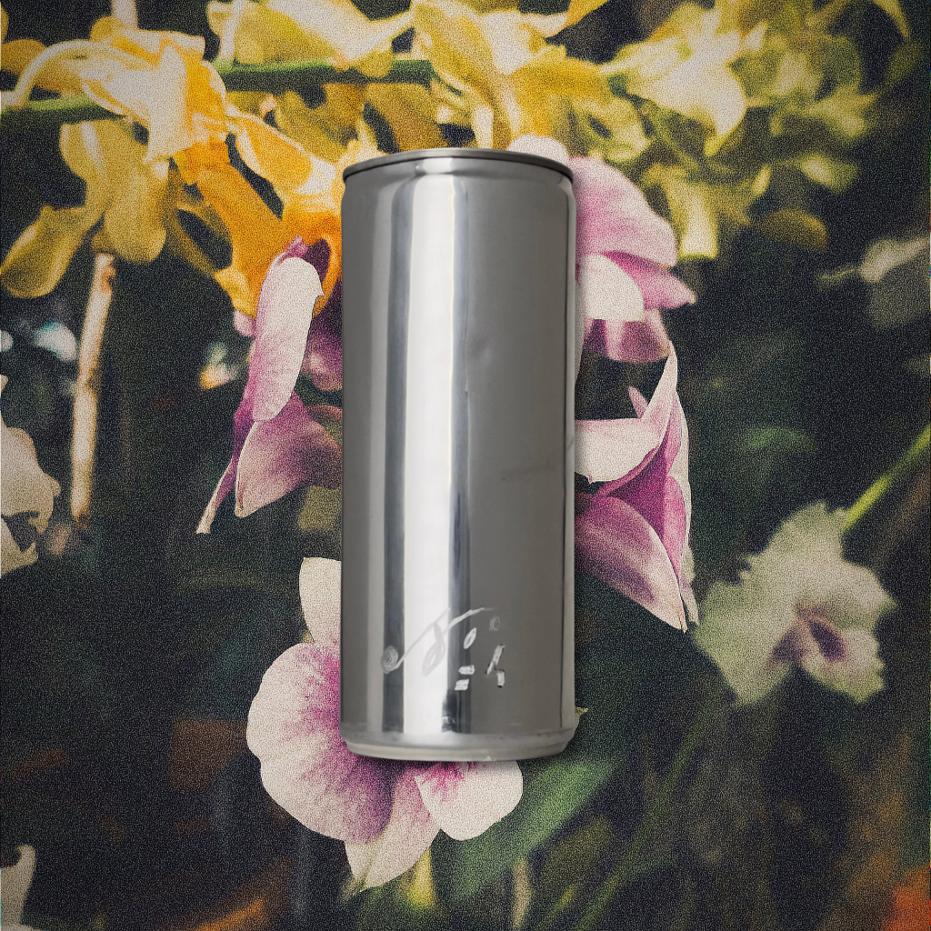 Sloan Rose N°4 Orchid & Summer Storm candle in a reclaimed aluminum vessel, among orchids in dark, storm dimmed light.